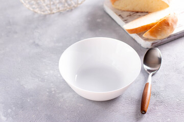Empty white plate on a concrete background