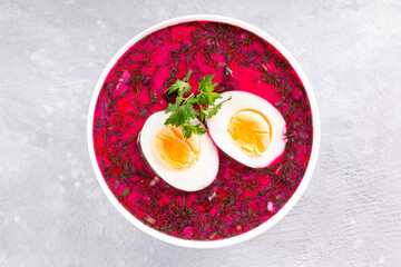 Traditional cold summer beetroot soup with vegetables, top view