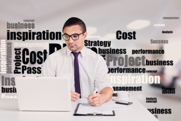 Happy young man works on his laptop at the table