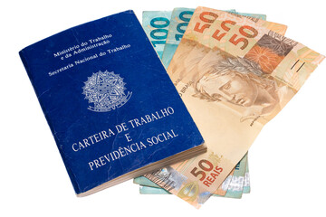 .Brazilian work and social security portfolio with several Brazilian money bills and coins photographed on white background