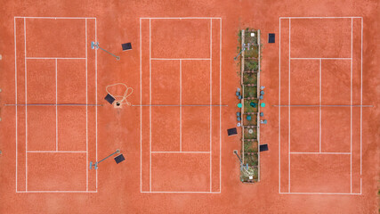 Aerial view drone shot top down on tennis court three playground with clay in day empty no people