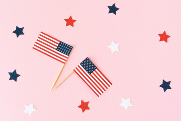 Two usa flag toothpick and star on pink background, flat lay. 4th of july, happy independence day. Funny celebration in America.