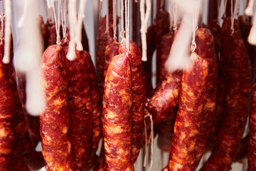 Factory for the production of meat products, cured sausages. Traditional spicy sausage hanging to dry, covered with fungus. Concept of handmade meat products. Delicacy. 