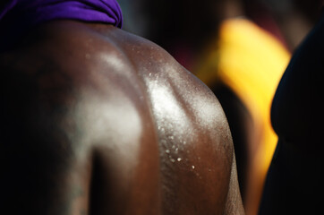 Detail close-up of the back of unrecognizable black man on the beach