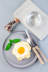 Trendy cloud or fluffy egg dish on gray plate, vertical, top view