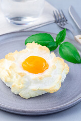 Oven baked cloud or fluffy egg dish on  gray plate, vertical