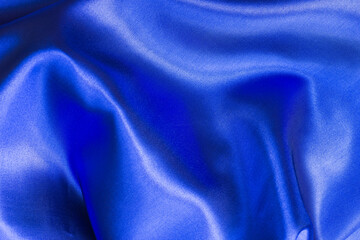 Blue Satin Fabric as Background Texture. Folded silky satin textile
