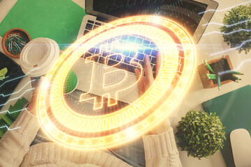 Double exposure of woman hands working on computer and blockchain theme hologram drawing. Top View. bitcoin cryptocurrency concept.