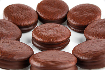 chocolate-coated cookies on a plate, isolate on a white background