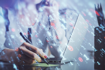 Multi exposure of woman hands working on computer and data theme hologram drawing. Tech concept.