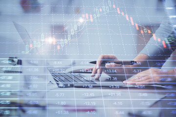 Multi exposure of woman hands typing on computer and financial chart hologram drawing. Stock market analysis concept.