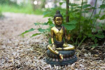 Closeup of golden buddha statue in the garden