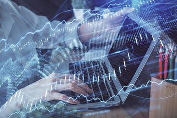 Double exposure of woman hands typing on computer and forex chart hologram drawing. Stock market invest concept.