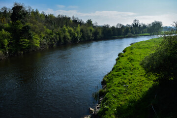 Fototapeta na wymiar Peaceful river flowing around the corner