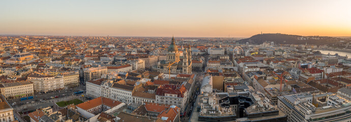 Panoramic aerial drone shot of St. Stephen Basilica during Budapest sunset hour in winter