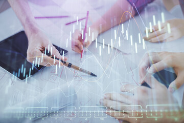 Double exposure of forex graph drawing and man and woman working together holding and using a mobile device. Trade concept.