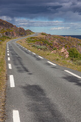 The twisting road along the stony coast of the Barents Sea, Finnmark, Norway