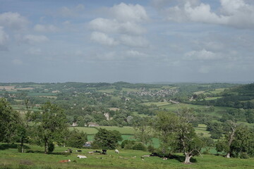 countryside landscape with rolling hills with and blue cloudy sky