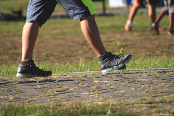 Fototapeta na wymiar A man wearing sports shoes while walking in the park