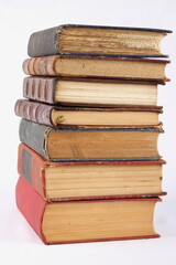 Pile of weathered and very old books on white background.