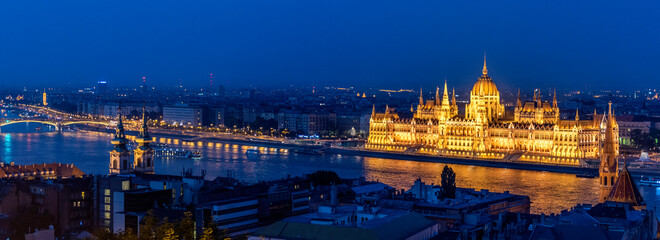 Fototapeta na wymiar A panoramic night pic of Budapest Hungary with the government building glittering on the Danube river