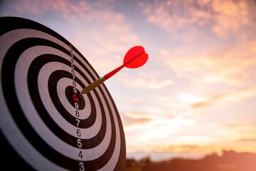 business marketing as concept. Red dart arrow hitting in the target center of dartboard Target hit...