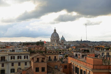 Fototapeta na wymiar View of Rome at dusk with dark clouds, Italy. Landscape view, of the Cupolas Church. Italy
