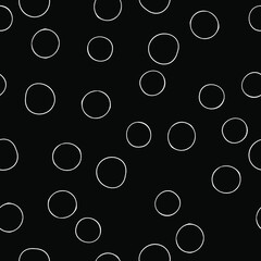 Seamless pattern with white contour circles on a black background. Vector image.