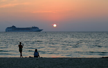 Sunset from Patong beach. Thailand. View of the summer season along with the palm trees fund in Phuket.