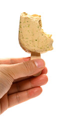 hand holding a mostly eaten seaweed flavor popsicle on white background