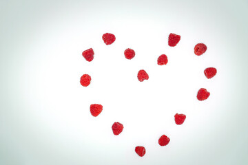 Close-up view of fresh raspberries making a heart shape
