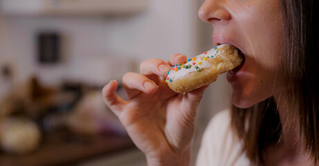 Young woman eats sweet sugar doughnuts - home shooting