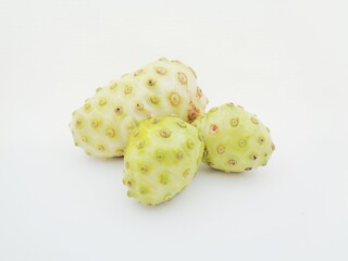 Morinda citrifolia (great morinda, Indian mulberry, noni, beach mulberry, cheese fruit) with white background. 