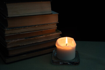 Still life with candle and vintage books