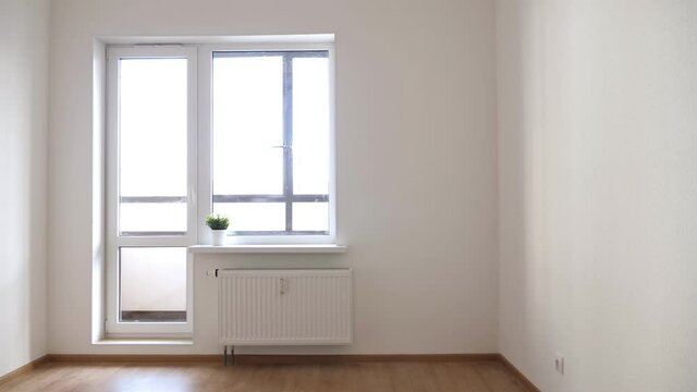 Empty unfurnished room with walls, window and radiator, nobody