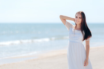 Fototapeta na wymiar Fashion Woman in Long White Dress on the Beach