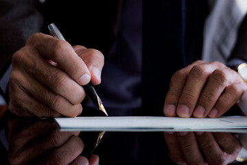 businessman signing a document