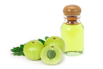 Amla fruit or indian gooseberry with green leaf and glass bottle of essential oil extract isolated on white background. 