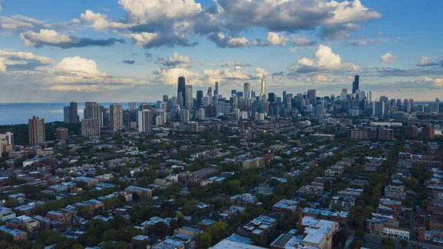 Aerial Hyper Lapse of Chicago Downtown Skyline. Modern city with parks and urban grid, sky with moving clouds