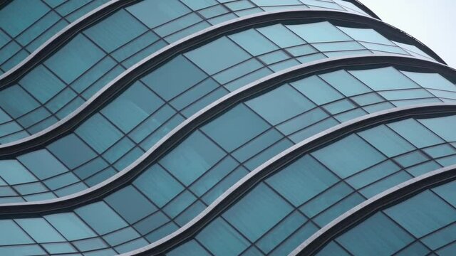 Curved glass business skyscrapper with blue reflections in Vancouver, Canada