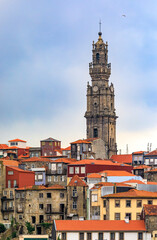 Fototapeta na wymiar Baroque Torre dos Clerigos church bell tower viewed over the terracotta roofs of the old town of Porto, Portugal
