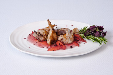 A plate of quail on a white background