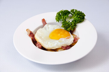 A plate of fried egg on a white background