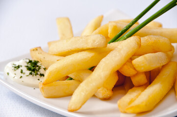A plate of french fries on a white background