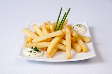 A plate of french fries on a white background