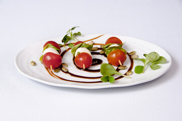 Plate of tomato and cheese salad on a white background