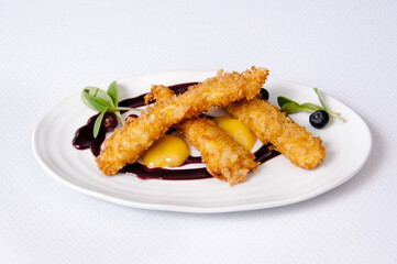 Breaded chicken dish on a white background
