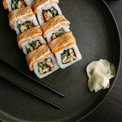 Maki sushi. Maki roll with seared salmon and omelette. Restaurant serving. The view from the top