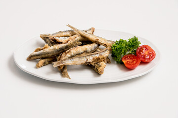 A plate of sardines on a white background