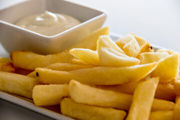 A plate of french fries on a white background